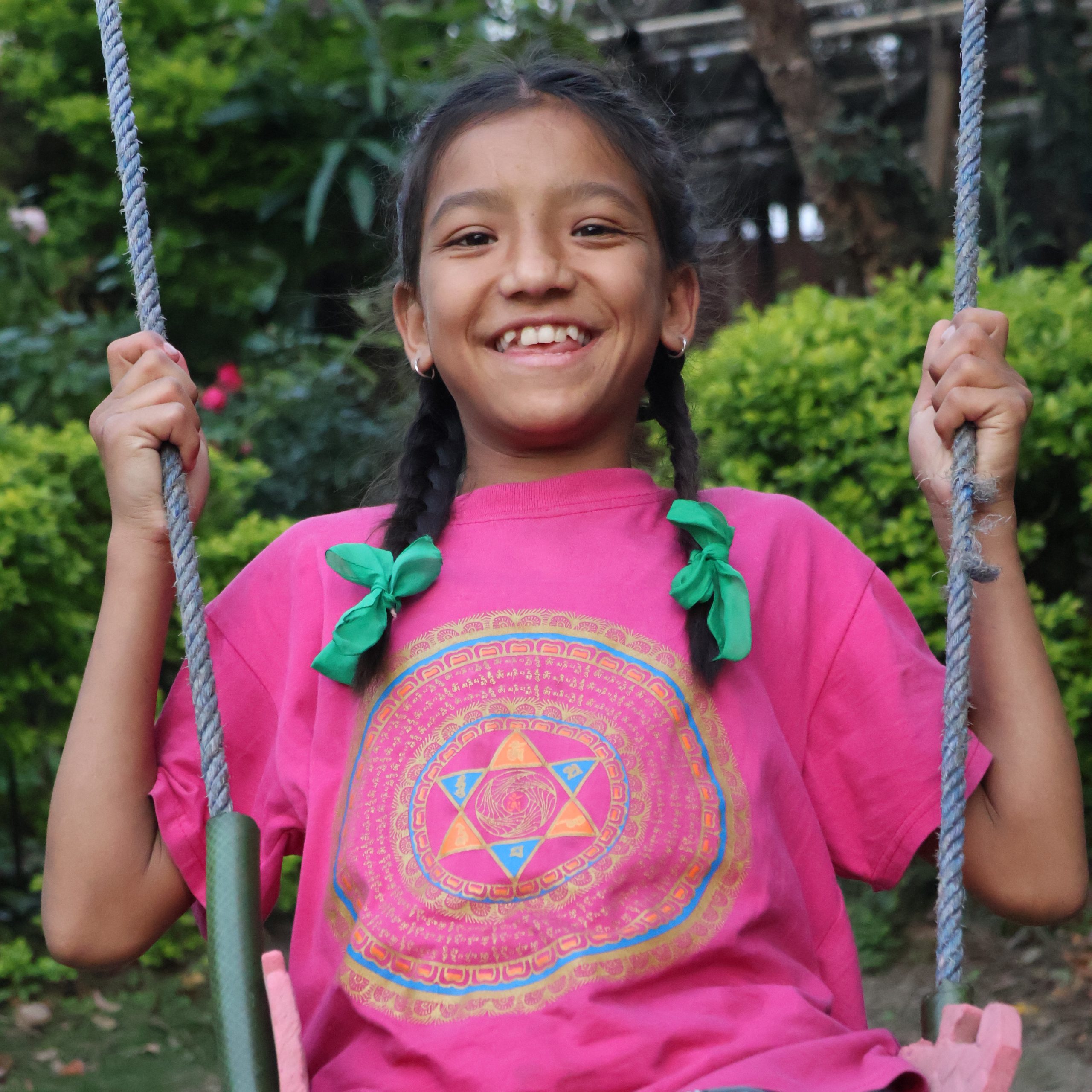IMG_20250701_214147 Young House Daughter smiling while sitting on a swing at the family residence