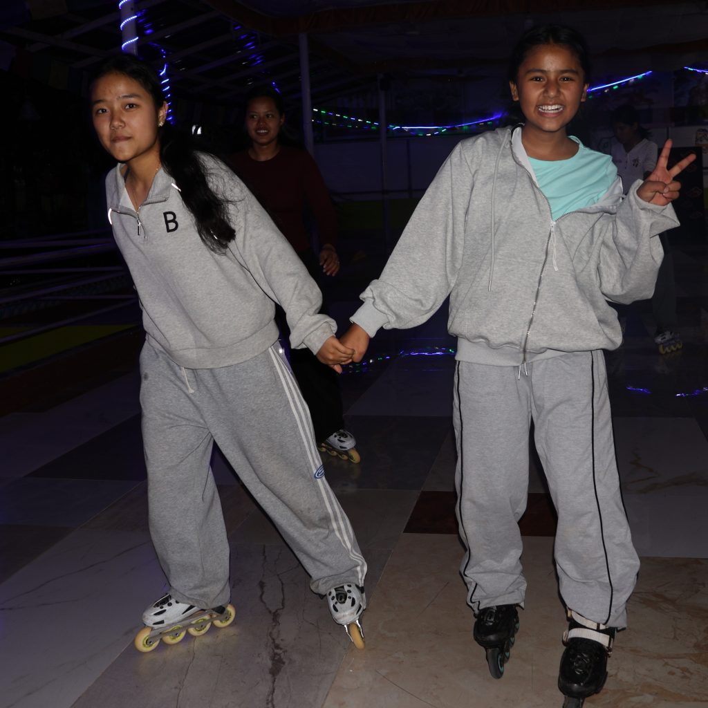Sabina and Astha roller skating during a night out