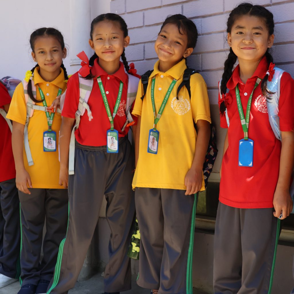 House Daughters Rejina, Amina, Shrijana, and Rita standing together at school