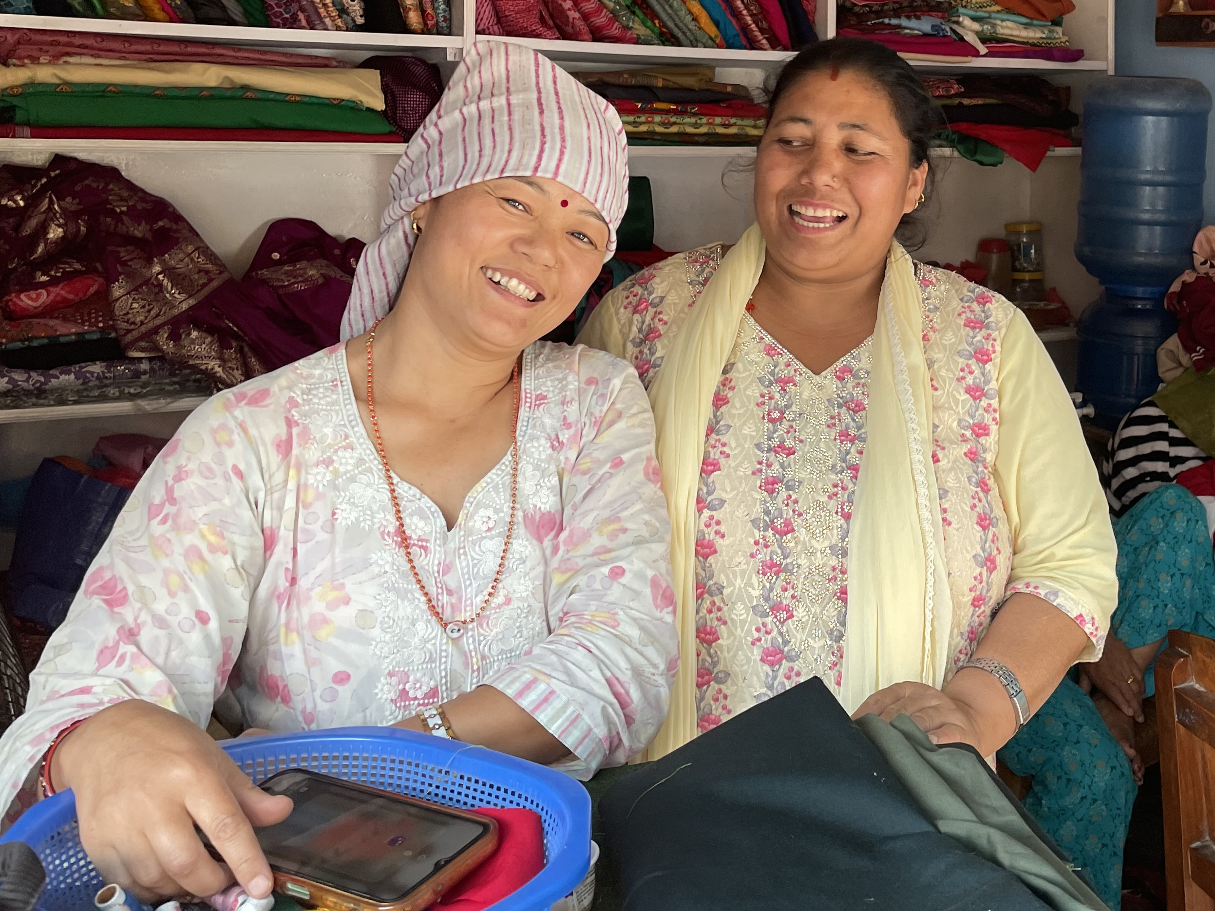 Lopsang with sewing instructor Dev Kala at Lop­sang’s tailoring shop